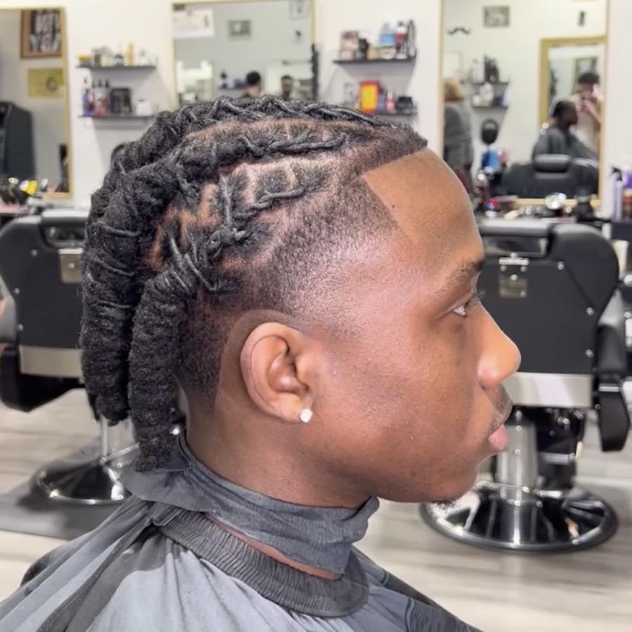 Locs with a braided pattern, high fade and lineup