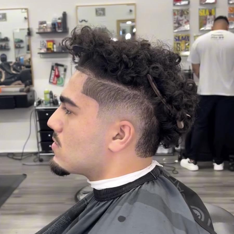 Curly mullet with a mid fade and lineup